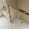 A modern bathroom with a sink and a walk-in shower. Produktbild-Vorschau