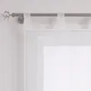 A close-up view of a white sheer curtain hanging from a metal curtain rod with a decorative antler finial. Produktbild-Vorschau