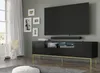 A modern living room with a TV mounted on the wall above a black media console with gold legs. Artwork is displayed on the wall. Podgląd zdjęcia produktu