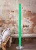 A green LED floor lamp with a bubble effect stands next to a wooden chair with a striped blanket and pillow. Produktbild-Vorschau