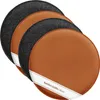 A set of four round reversible seat cushions, two with a brown faux leather side and two with a gray felt side, are stacked and angled on a white background. Produktbild-Vorschau