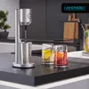 A modern kitchen counter with a drink mixer and two glasses of drinks. Anteprima dell’immagine prodotto