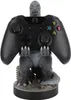 A Godzilla figurine holding an Xbox controller. Produktbild-Vorschau