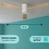 A modern ceiling fan with wooden blades is shown mounted on a white ceiling against a teal wall. Náhled obrázku produktu