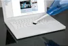 A handheld vacuum cleaner with a brush attachment is being used to clean a white laptop keyboard. Podgląd zdjęcia produktu
