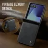A black leather flip case for a smartphone, shown on a textured brown background. Produktbild-Vorschau