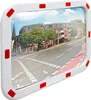 A convex mirror with a white frame and red reflectors, reflecting a street scene with buildings and a road. Podgląd zdjęcia produktu