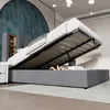 A bed with its storage compartment open, showing the mattress and slatted base. Produktbild-Vorschau