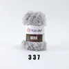 A ball of grey, fluffy yarn with a label indicating the brand and product name. Náhľad obrázku produktu