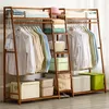 A bamboo garment rack filled with clothes and storage boxes. Produktbild-Vorschau
