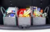 The image shows the interior of a car trunk filled with three felt storage bags containing groceries and household items. Produktbild-Vorschau