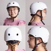 A collage of four images showing a young girl wearing a white helmet from different angles. Voir les images du produit