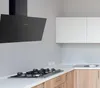 A modern kitchen with a black range hood and gas stove. Produktbild-Vorschau
