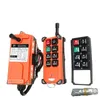 Three industrial remote controls are displayed against a white background. One is a larger orange unit with a cable, and the other two are smaller orange and black units with buttons. Podgląd zdjęcia produktu