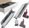 A collage showing drawer slides and a drawer with organizers. A portion of a drawer with cutlery organizers is visible on the left. The main focus is on two sets of drawer slides, one fully assembled and the other separated into components, with red and gr Náhled obrázku produktu