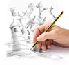 A hand holding a pencil is drawing on a piece of paper. The drawing depicts a futuristic city. Voir les images du produit