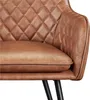 Close-up view of a brown quilted armchair. Produktbild-Vorschau