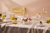A table set with desserts, drinks, and candles, suggesting a celebratory or gathering setting. Náhľad obrázku produktu