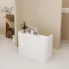 A white reception desk with a computer and a vase of flowers on it, placed in a modern office or retail space. Produktbild-Vorschau