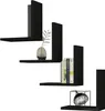 Four black L-shaped shelves are arranged in a staggered pattern against a white background. The shelves hold decorative items such as a vase with a plant and books. Podgląd zdjęcia produktu