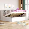 A white bed with storage and LED lighting is shown in a bedroom setting. Produktbild-Vorschau