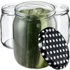 Three glass jars, one filled with pickles and sliced cucumbers, with a black and white polka dot lid in the foreground. Voir les images du produit