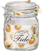 A clear studio shot of a glass jar with a clamp lid, filled with what appears to be a white substance. The jar is decorated with a patterned label featuring illustrations of apricots and text. Produktbild-Vorschau
