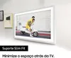 A TV mounted on a wall, displaying an image of two people on a scooter. There are also two framed pictures on the wall to the left of the TV. Produktbild-Vorschau