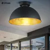 A black ceiling lamp with a gold interior is shown mounted on a white ceiling. Anteprima dell’immagine prodotto