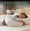 A young girl sleeping on a large pillow in a bedroom. Produktbild-Vorschau