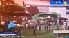 A screenshot from a video game showing a train station entrance with people around. Produktbild-Vorschau