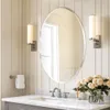 A bathroom vanity with a mirror, sink, faucet, and flowers. Podgląd zdjęcia produktu