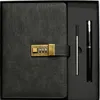 A black notebook with a gold combination lock and a pen are displayed in a black box. Náhľad obrázku produktu
