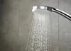 A close-up of a shower head spraying water. Produktbild-Vorschau