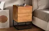 A wooden nightstand with two drawers sits next to a bed. Anteprima dell’immagine prodotto
