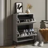 A shoe cabinet with shoes inside, placed in a room with a painting and a vase on top. Podgląd zdjęcia produktu
