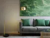 A modern living room scene with a sofa, floor lamp, and artwork. Anteprima dell’immagine prodotto