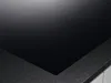 A close-up view of a black induction hob with a textured gray edge. Anteprima dell’immagine prodotto