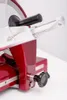 A close-up view of a red meat slicer. Náhled obrázku produktu