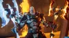 A muscular, bearded warrior character from a video game, holding two large axes, one glowing with ice and the other with fire, against a backdrop of flames. Produktbild-Vorschau