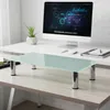 A glass monitor stand is placed on a desk in front of a computer. Produktbild-Vorschau
