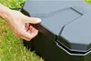 A hand is opening the lid of a black HEISSNER box for a garden socket, which is placed on grass. Anteprima dell’immagine prodotto