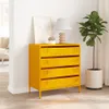 A yellow dresser with four drawers is placed in a room with a plant and a lamp. Podgląd zdjęcia produktu