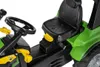 Close-up view of the seat, steering wheel, and green body of a toy tractor. Anteprima dell’immagine prodotto