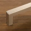 A close-up shot of a modern cabinet handle on a wooden surface. Produktbild-Vorschau