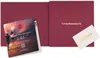 An open burgundy gift box with a brochure and a gift card inside. Produktbild-Vorschau