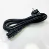 A black power cord is coiled on a white background. Voir les images du produit