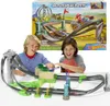 Two children playing with a Hot Wheels Mario Kart race track. Produktbild-Vorschau