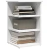 A white corner shelf unit with books and a storage box. Voir les images du produit