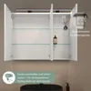 An open bathroom cabinet with glass shelves, a light, and a power outlet. Text overlays describe features. Produktbild-Vorschau
